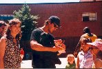 real nice picture of Sunglasses&BaseballCap!Keanu signing an autograph for some kids
