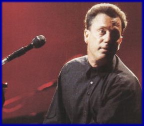 Billy Joel Sitting at Piano with microphone in his face