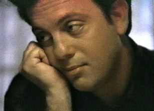 Billy Joel leaning on his hand on his chin