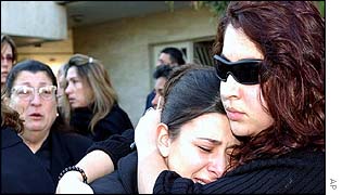 Relatives weep as Hobeika's coffin passes