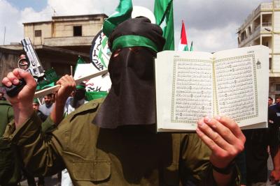 A Muslim
holding the Koran in his left hand and in the right hand, he holds a gun. Perfect
combination!!!