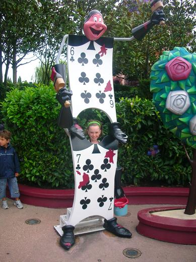 Isabelle standing by a character of Alice in Wonderland