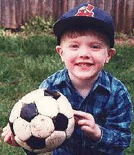 Aaron with soccer ball in backyard