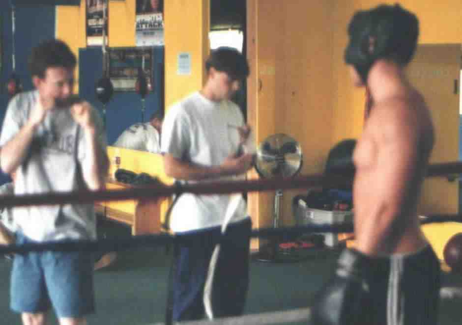 Boxer gets some mid-round pointers from the trainer. Photograph copyright 1999. All rights reserved.