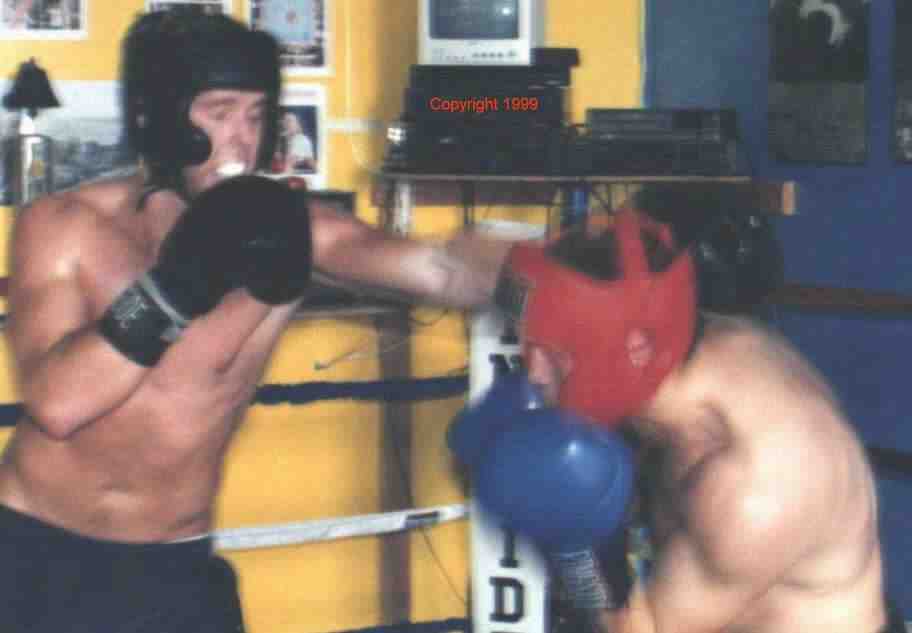 Ducking under the jab. Sparring is a way to apply what you learned in the drills. Photo copyright 1999. All rights reserved.