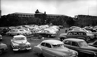 VIEW WEST LOOKING ACROSS CROWDED PARKING LOT FULL OF AUTOS LOOKING FROM VERKAMPS TOWARDS THE EL TOVAR HOTEL & HOPI HOUSE. JULY 1951.  NPS PHOTO BY DAZEY