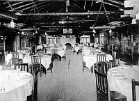 LOOKING SOUTH ACROSS THE EL TOVAR HOTEL DINING ROOM. AISLE FROM FIREPLACE DIVIDES ROOM. CIRCA 1906 FRED HARVEY PHOTO.