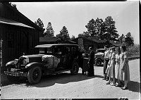 LODGE EMPLOYEES STANDING BY A UNION PACIFIC TOURING CAR, SINGING FAREWELL TO GUESTS AT THE GRAND CANYON LODGE, NORTH RIM. SUMMER 1933<br>