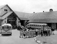 THE FAMOUS EMPLOYEE &quotSING-AWAY" CEREMONY AS VISITORS LEAVE THE GRAND CANYON LODGE, ON THE NORTH  RIM. TWO TOUR BUSSES. 23 JUNE 1949 NPS PHOTO BY EDEN
