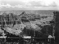 VIEW OF GRAND CANYON FROM THE PORCH OF THE ORIGINAL GRAND CANYON - NORTH RIM - LODGE SHOWS DEVA, BRAHMA & ZOROASTER TEMPLES AND BRIGHT ANGEL CANYON BEYOND RAILING. 14 JULY 1930. NPS, GRANT.