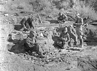 CCC ENROLLEES EXCAVATING THE FOSSIL FERN EXHIBIT QUARRY ON THE S KAIBAB TRAIL. CIRCA 1935. NPS.