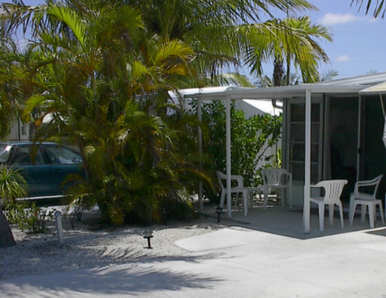 Enjoy the breeze under the palm trees on the front porch.