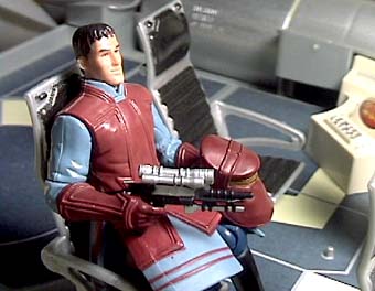 The figure seated in the Queen's Royal Starship.