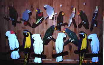 photo of a group of hanging wooden parrots