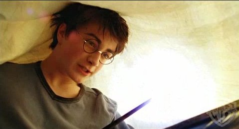 Harry doing homework in bed