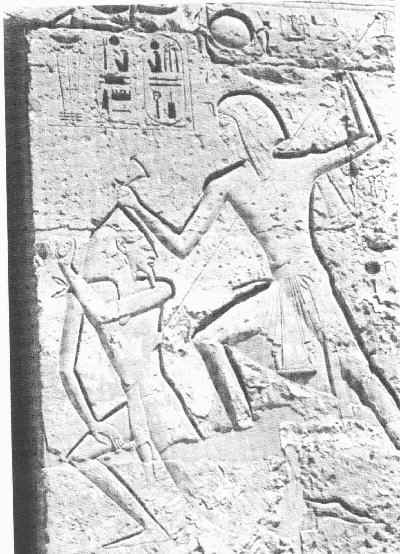 Figure i) Ramesses 3 smiting a Libyan; from his mortuary temple at Medinet Habu (Shaw 1991)