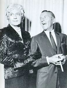 [Jack dressed as Gracie, along with George, is performing 'Lamb Chops']