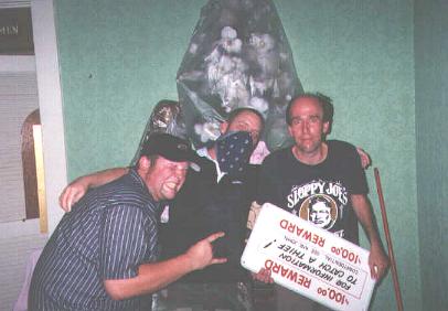 Three Lurkers pose with the now-famous '$100 Reward....To Catch a Thief!' sign from the kitchen