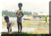 kids watching the fish, as a ferry passes by