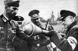 An elderly german Volkssturm is being instructed on the Panzerfaust