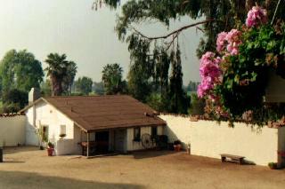 The yard and caretaker's house appear as miniature.