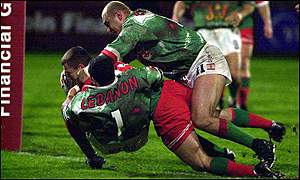 Iestyn Harris breaks the tackle of Hazem El-Masri of Lebanon to score