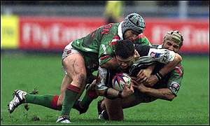 Henry Paul of New Zealand is tackled by Paul Khoury and George Najjarin of Lebanon.