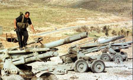 A resistance fighter examines abandoned artillery