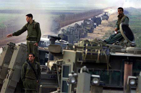 Israeli armour waits to cross the border