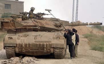 A news crew interviews an Israeli tank commander upon returning to Israel.