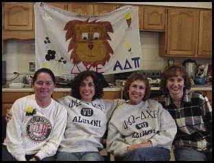Alumnae with banner.