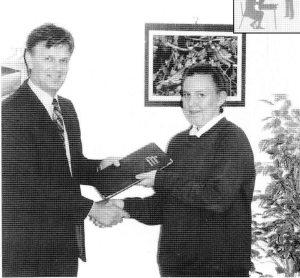 Mr Buck presenting a NRA folder..