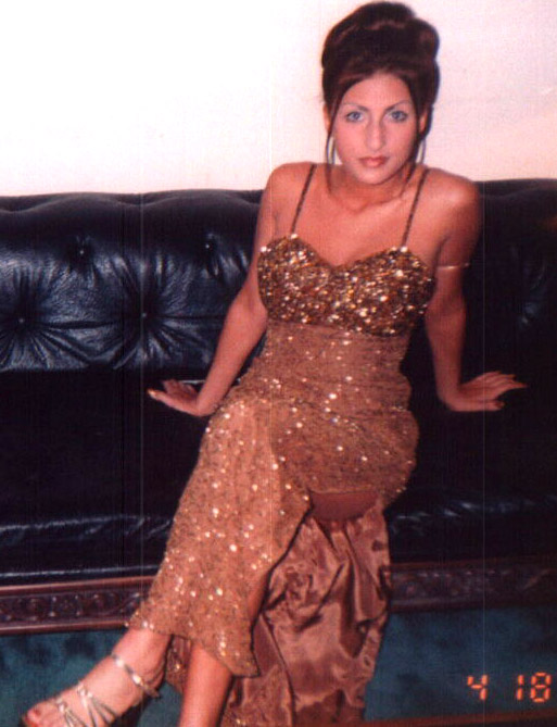 Chanell on couch in front room in a gold dress