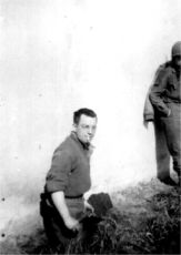 Soldier digging next to building