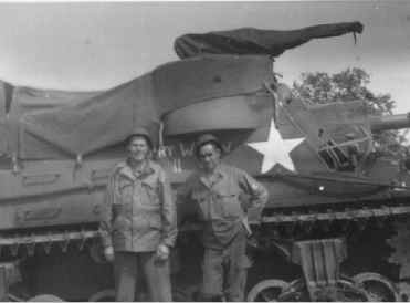 Two soldiers beside M7 named "Merry Widow II"