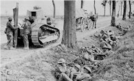 Canadian troops take cover in a ditch alongside the road from Arras to Cambrai. Aug-Sep 1918