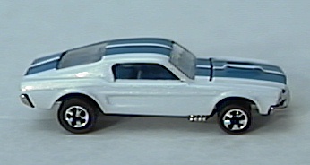 white '67 Mustang w/
redlines