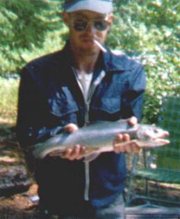 Hank holding 22-inch rainbow trout caught at Ptarmigan Creek, Alaska