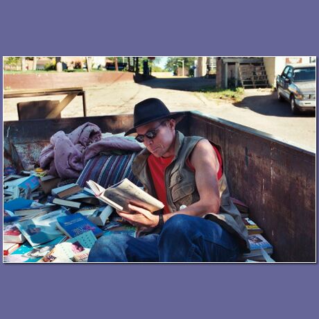 [Street Librarian in Dumpster full of books]
