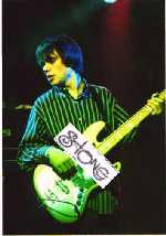 damon playing bass, looking left
