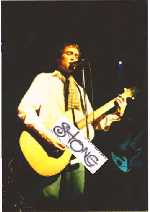 simon on acoustic guitar during Lining Your Pockets