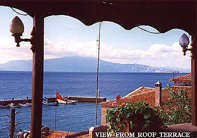 Roof restaurant with view over harbour, Lesbos in the distance