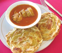 Chicken curry can be served with roti canai or roti jala