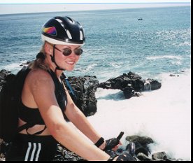 Debbie on bike along ocean