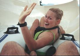 Debbie waving while hurtling down a water slide