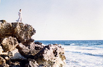 Image of Elizabeth on cliff by ocean in Cancun