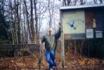 Scott standing at a sign on the top of Sassafras Mountain