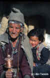 An old ladakhi with a prayer wheel
