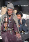 An old ladakhi with a prayer wheel