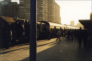 Train nearly loaded. Note the standees on the locomotive behind the post. December 1999.